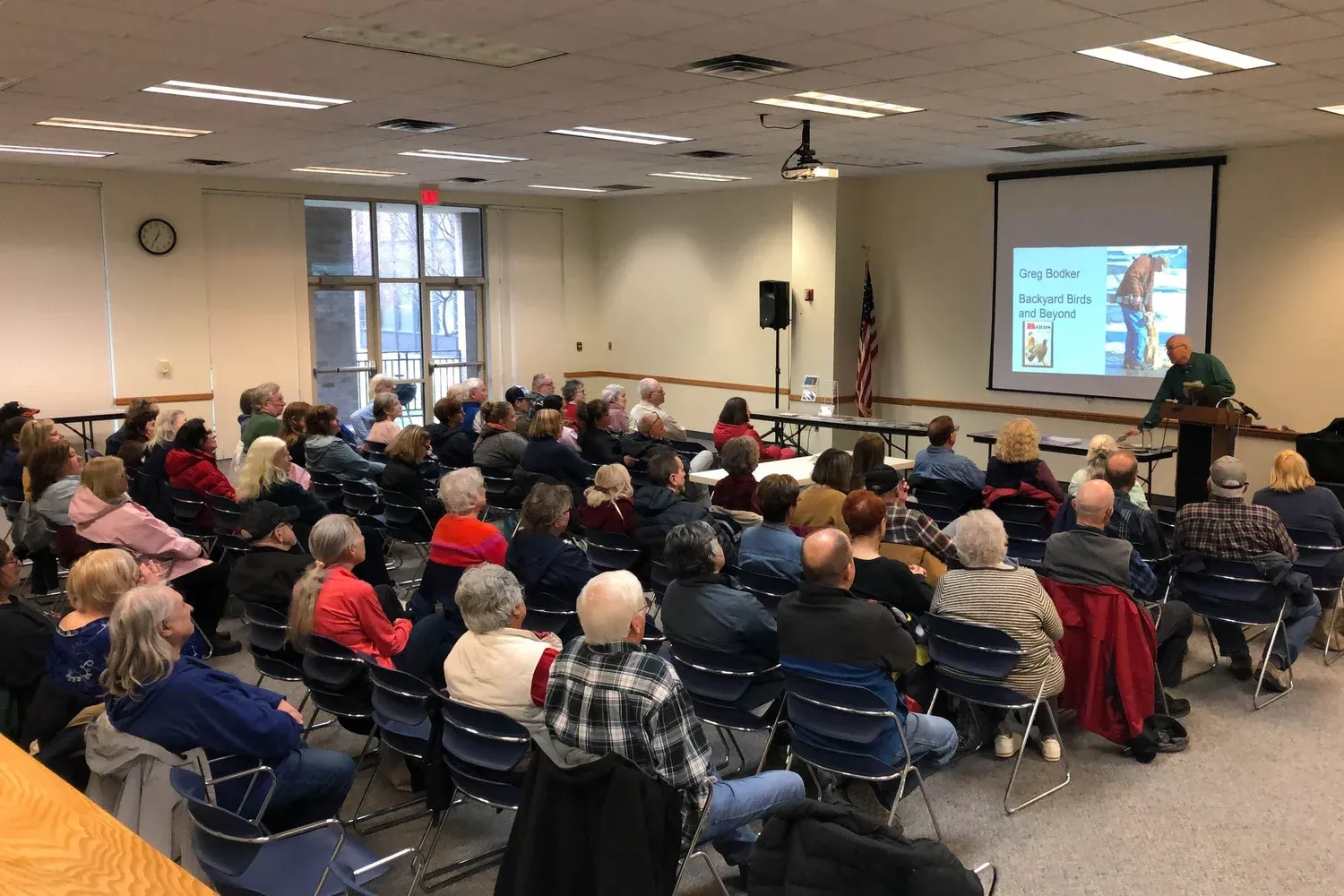 A full room of attendees enjoying a Backyard Birds and Beyond presentation.